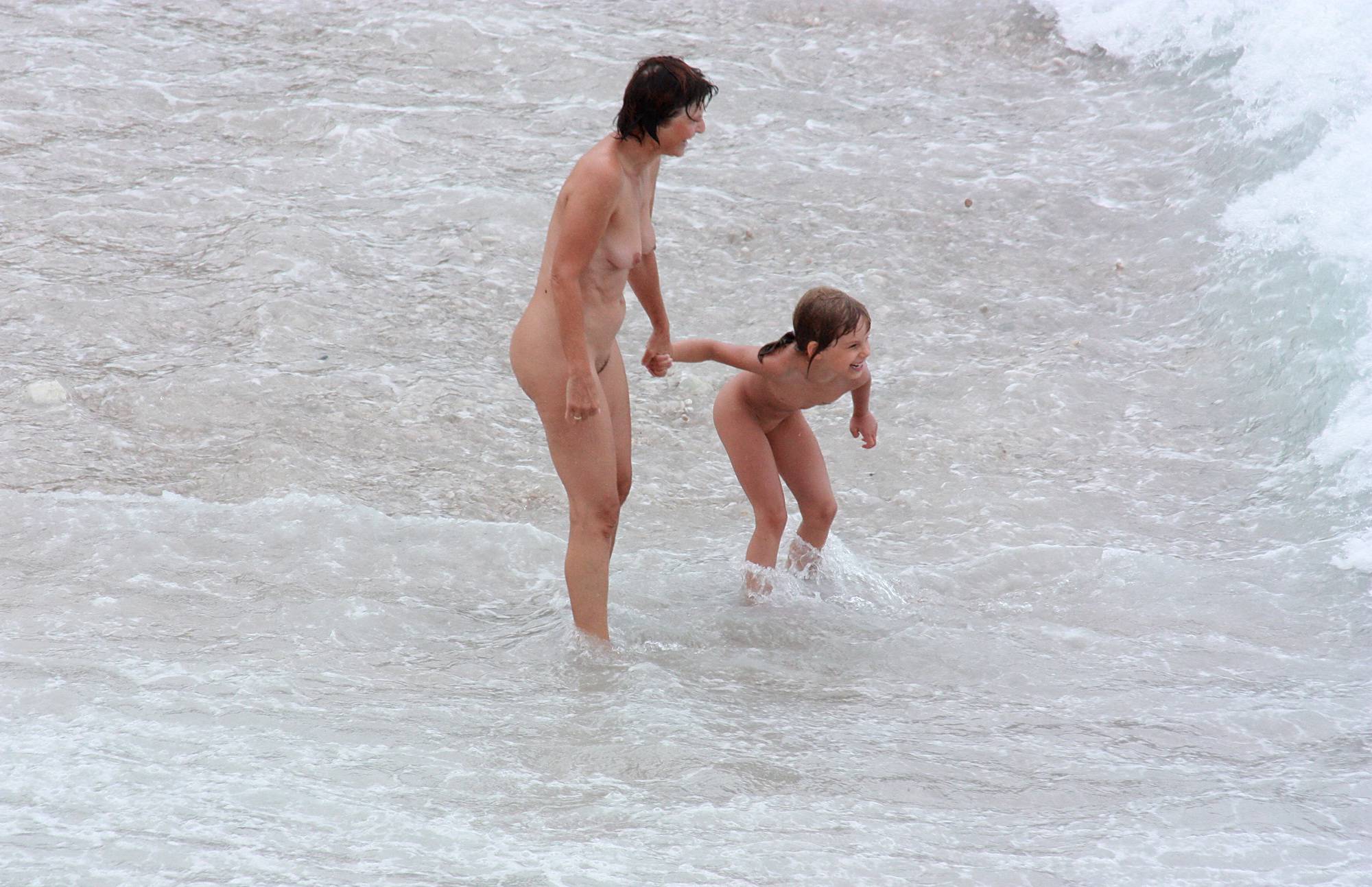 Nudist Gallery Wading In Coastal Waves - 2